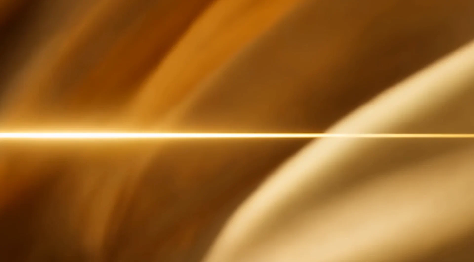 Abstract amber light crossing a reflective golden surface