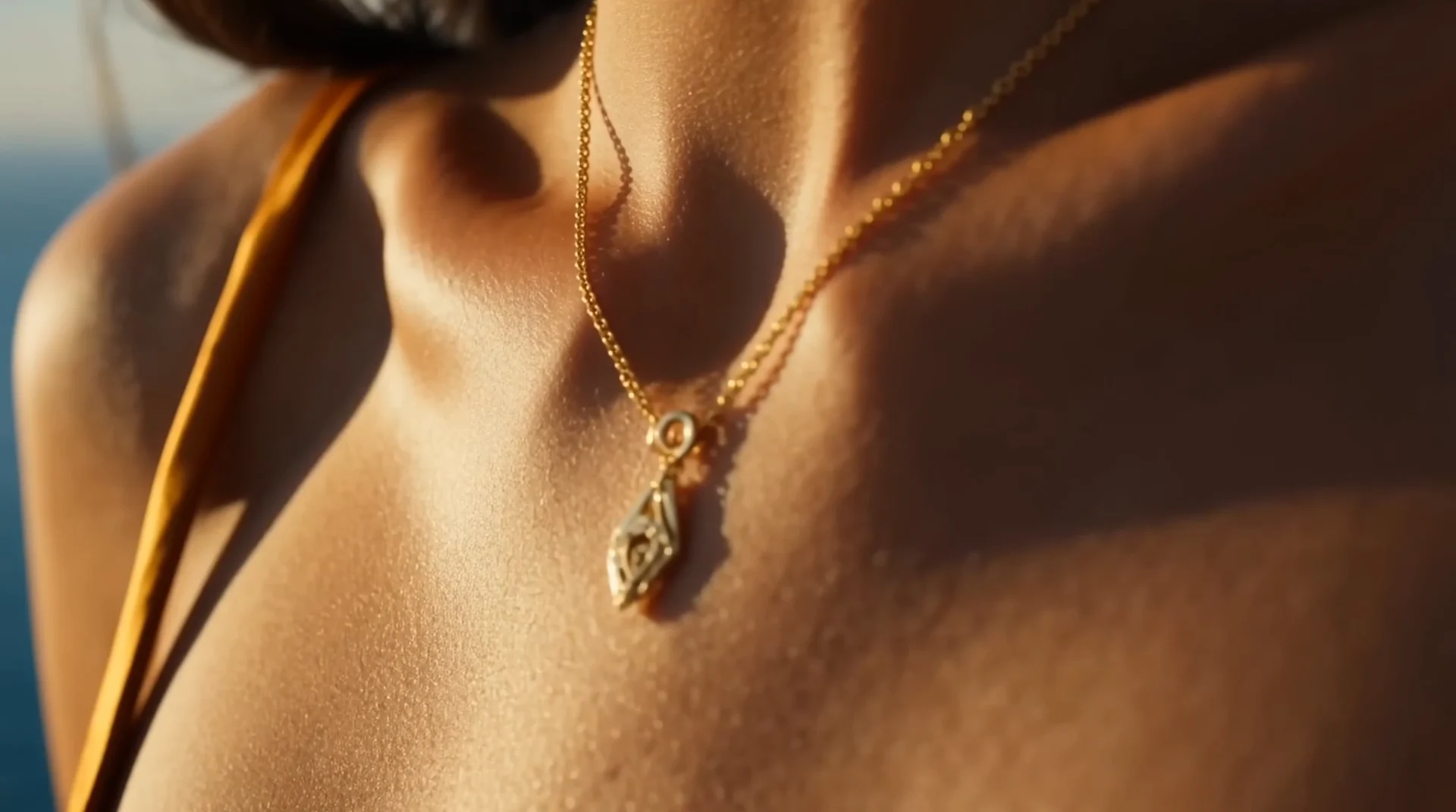 Close crop of skin, silk and gold jewelry