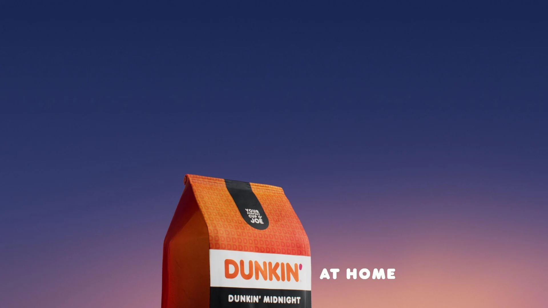 Dunkin' Midnight coffee pack against a deep violet gradient