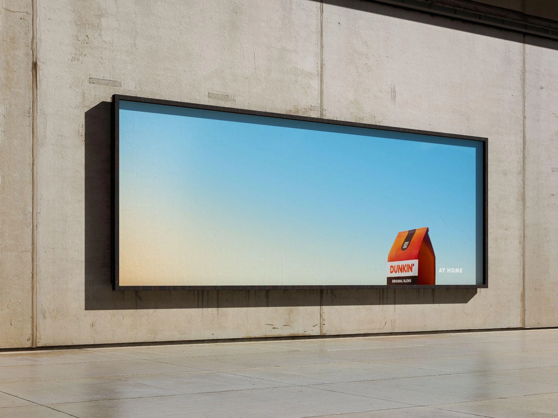 Dunkin' at Home campaign shown on a wide outdoor billboard