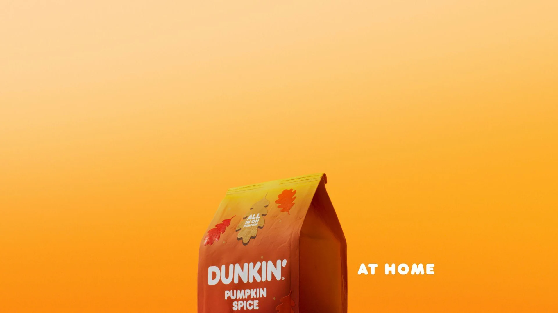 Pumpkin Spice coffee pack against a saturated orange background